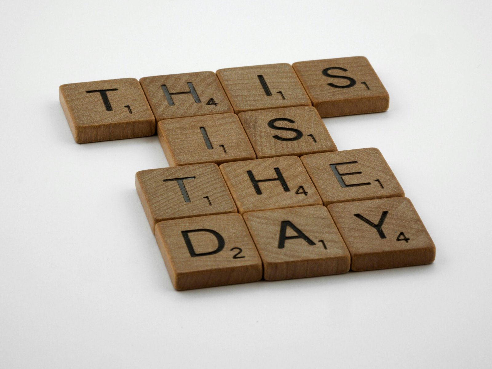 Wooden tray with alphabet blocks spelling 'this day' symbolizing the importance of focusing on the present and getting things done today